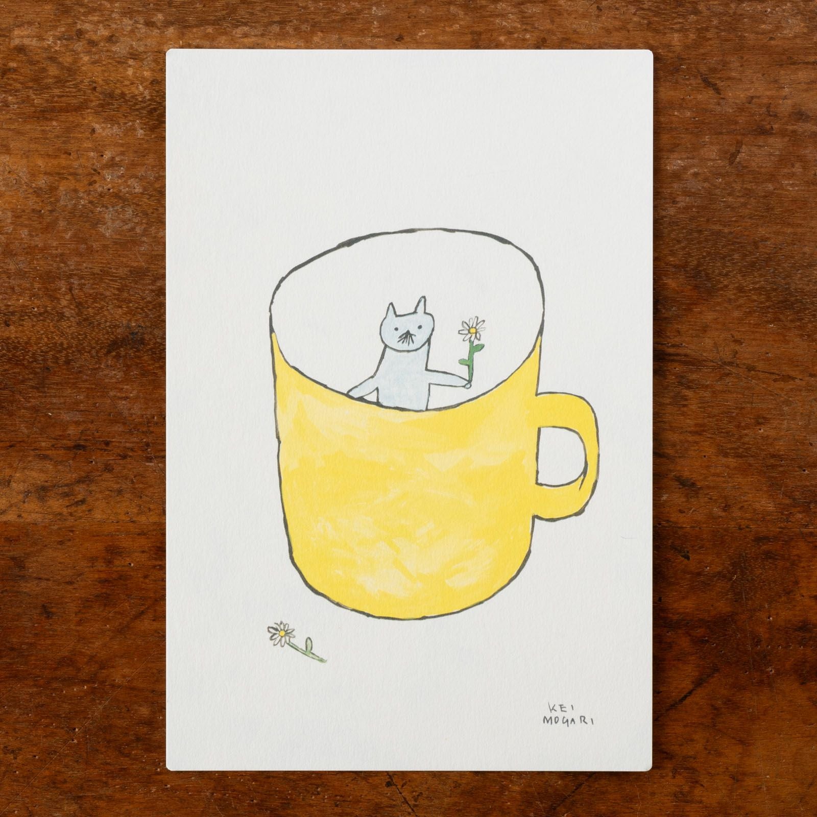 猫が黄色いコップの中にいるデザイン